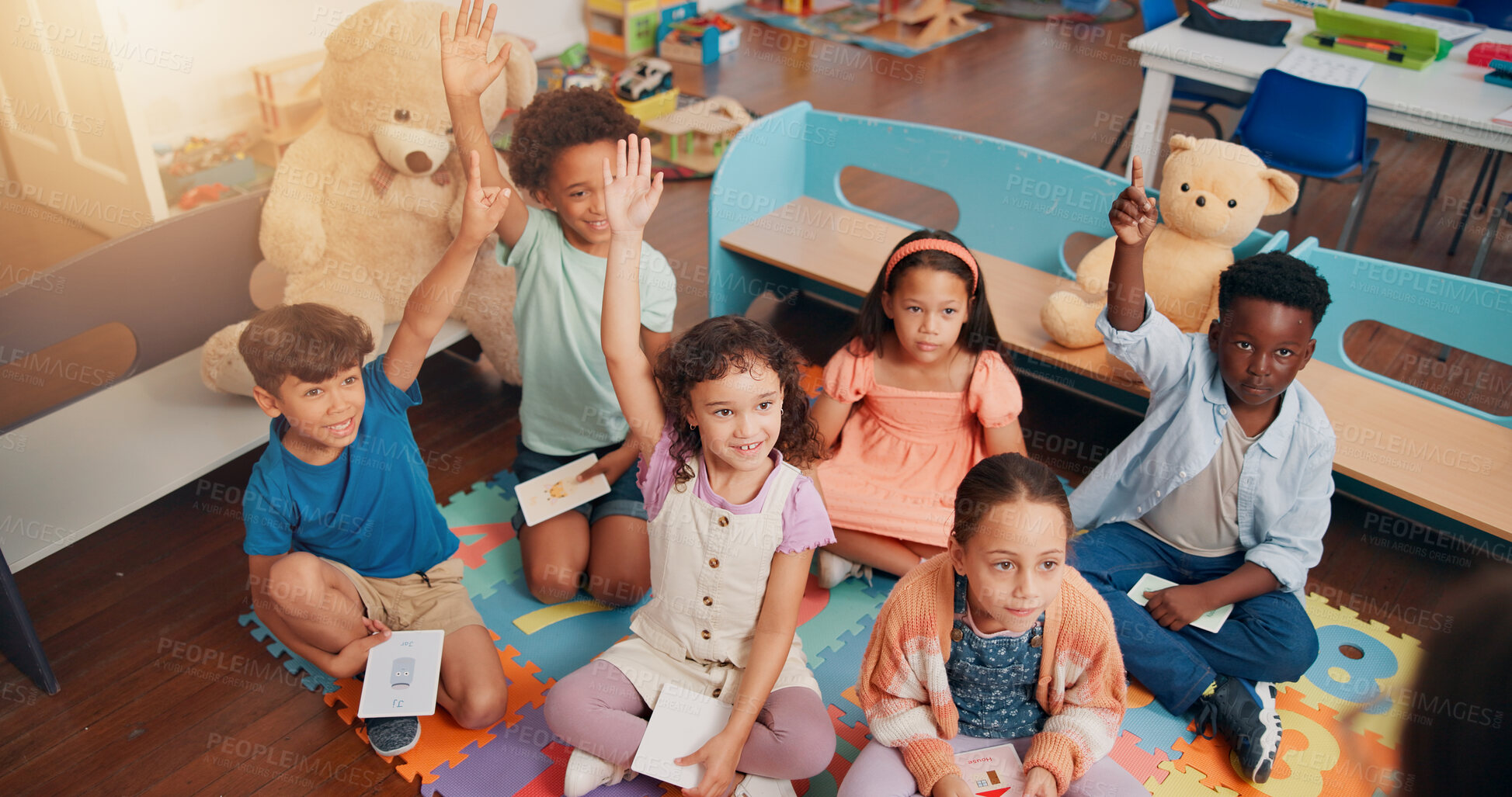 Buy stock photo Lesson, kids and hands raised with answer in classroom for flash card questions, knowledge or quiz feedback. Above, diversity people or students for learning development, study or creative assessment