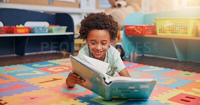 Buy stock photo Boy, reading book and education on floor in classroom for development, storytelling or knowledge at academy. Child, learning and study for scholarship, smile or info with course at elementary school