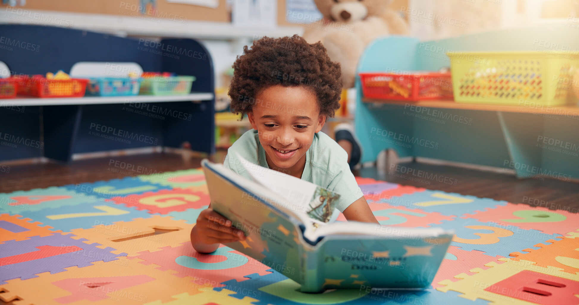 Buy stock photo Boy, reading book and education on floor in classroom for development, storytelling or knowledge at academy. Child, learning and study for scholarship, smile or info with course at elementary school