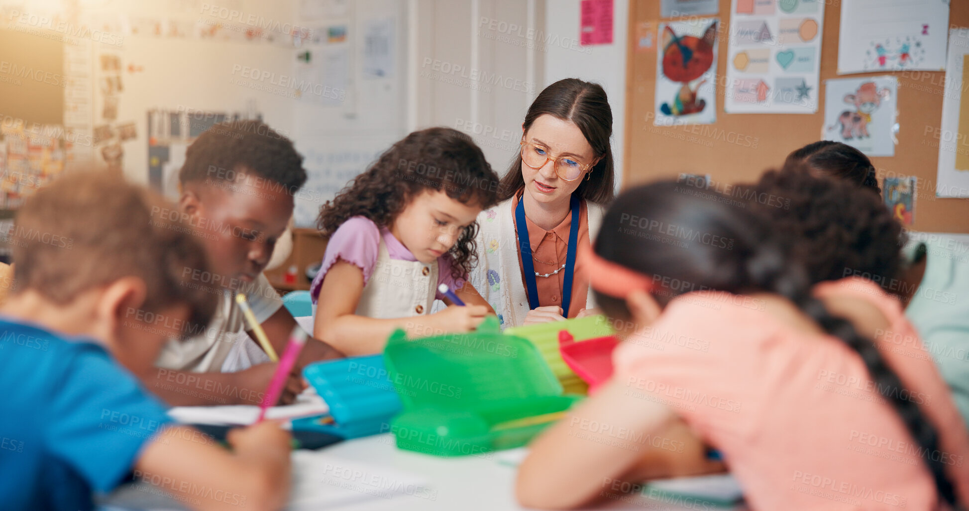 Buy stock photo Writing, education and teacher helping children in classroom for language development, learning or growth. Notebook, advice and woman educator with kid students for lesson at elementary school.
