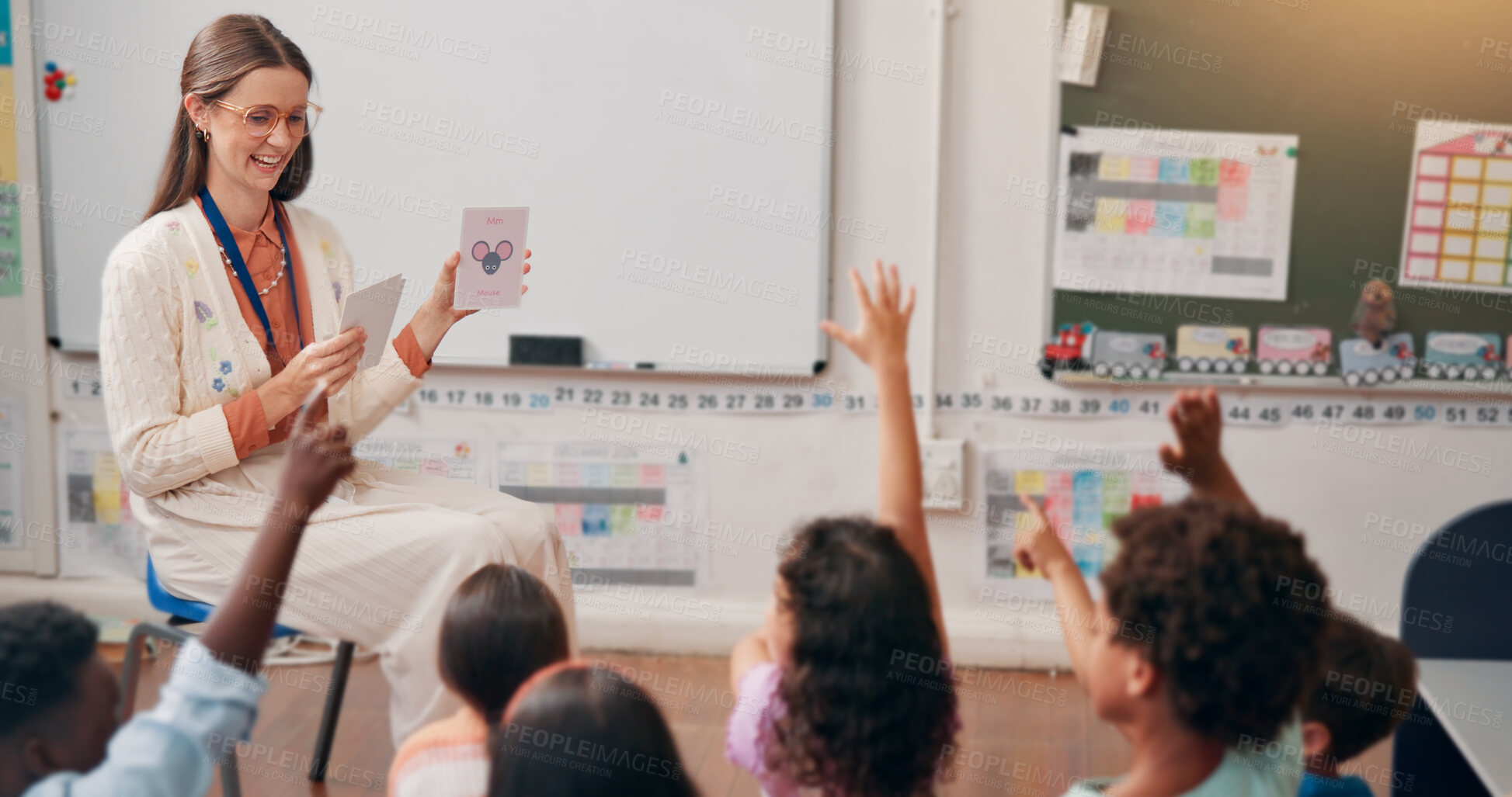 Buy stock photo Teacher, children and flash cards with question in lesson for animal alphabet, knowledge and feedback. Educator, people and students with hands raised for creative development, language quiz or smart
