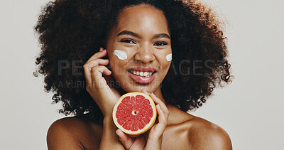 Buy stock photo Grapefruit, face cream and portrait of woman for skincare, natural product or facial treatment. Dermatology, studio and person with fruit for wellness, organic cosmetics or beauty on white background