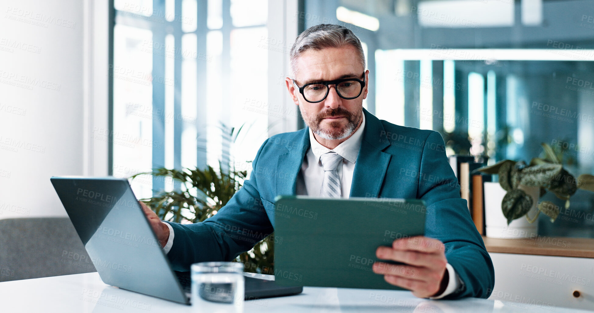 Buy stock photo Business man, tablet and office for financial email, revenue and investment on laptop. Digital technology, corporate and mature worker reading online for share price, trading information and profit