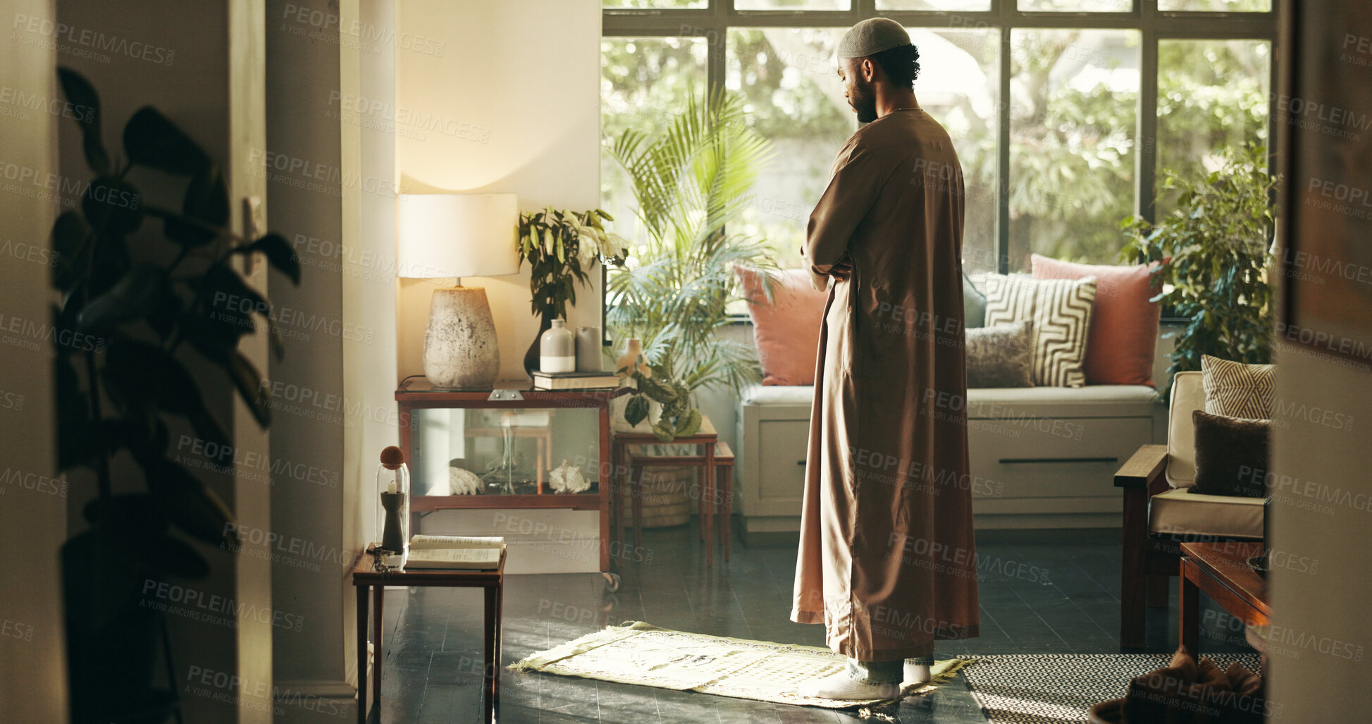 Buy stock photo Muslim, man and praying with belief at house for spiritual worship, praise Allah and faith in Ramadhan. Male person, prayer and dua in salah, forgiveness and mindfulness of fasting tradition in Islam