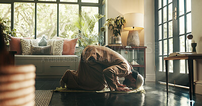 Buy stock photo Muslim, prayer and floor with man in home for ramadan kareem, spiritual and worship. Religion, faith and eid Mubarak with Islamic person and salah in living room for holy month, Allah praise and dua