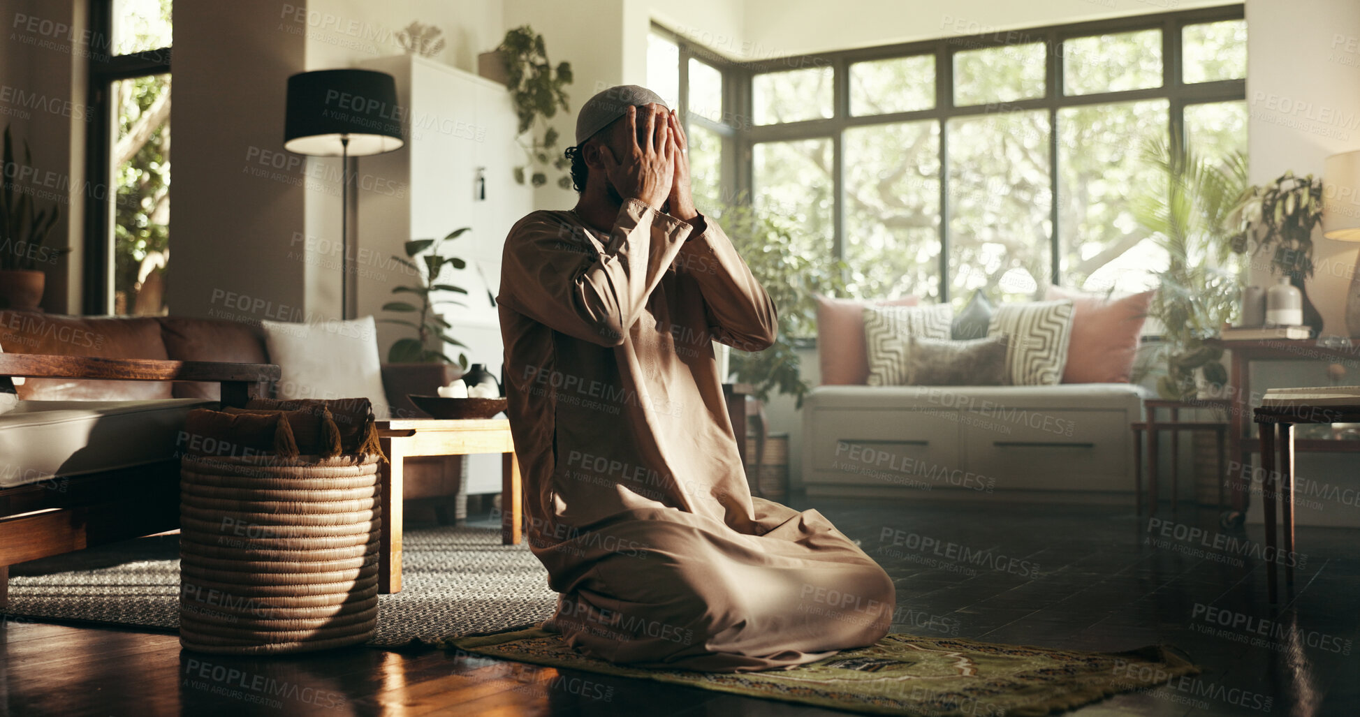Buy stock photo Muslim man, prayer and hands on face in home with mat for ramadan, Islam or relationship with Allah. Person, hijab and morning for faith, religion and trust in God for fasting, dua or praise in house