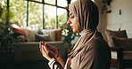 Muslim, religion and woman with praying in home for spiritual worship, Ramadan tradition and meditation on floor. Islamic faith, person and dua in living room for gratitude, salah and praise to Allah