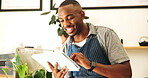 Black man, barista and tablet in coffee shop for small business, stock or reading good online review. Digital technology, smile or waiter in cafe for order, check inventory or planning menu for sales