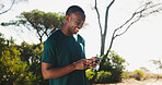 Outdoor, happy and man with smartphone, fitness and planning for workout on app, online and nature. Browsing, athlete and tracking performance on website, digital or black person with mobile for run