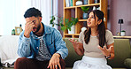 Argument, unhappy and couple in home, fight and newlyweds with financial disagreement or living room. Communication, stress and people with tension in relationship in lounge, frustrated and marriage