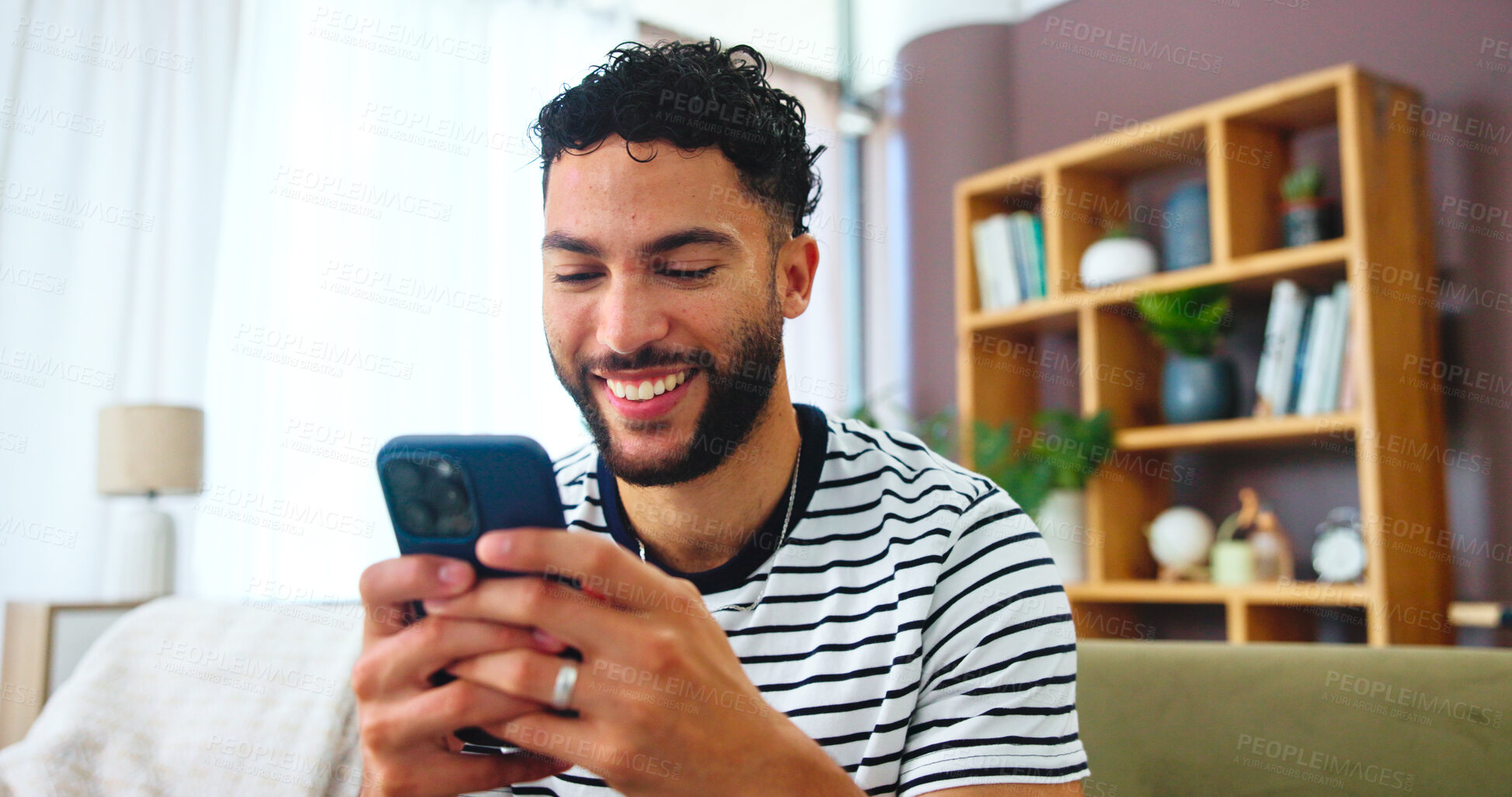 Buy stock photo Phone, relax and man on sofa in home with typing for social connection on mobile app. Happy, networking and male person with cellphone for texting on media with online dating in living room at house 