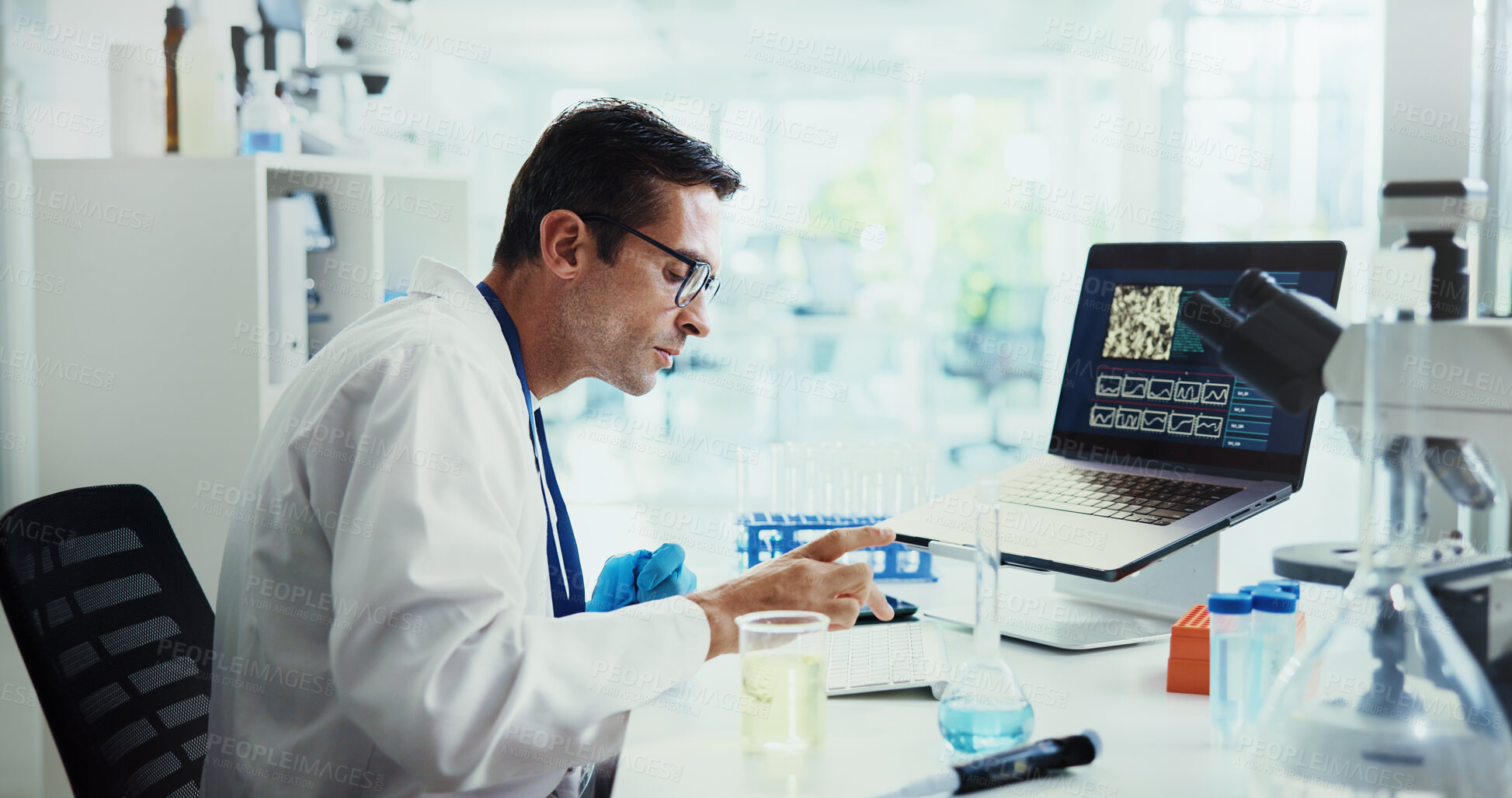 Buy stock photo Scientist, man and typing by computer in lab for medical research with feedback, review or vaccine development. Person, report and notes for chemical analysis with pharmaceutical drugs with laptop