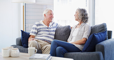 Buy stock photo Bonding, senior couple and conversation in home, smile and romance for relationship in living room. House, old man and woman in retirement, comfortable and elderly people in lounge, calm and marriage
