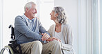 Holding hands, wheelchair and senior couple in home for bonding, empathy or trust for support. Retirement, marriage and happy mature man and woman together for compassion, care or loving relationship