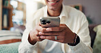 Cellphone, hands and man on sofa in home for social networking on mobile app for connection. Phone, communication and closeup of male person texting for online dating in living room at apartment.