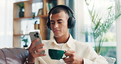 Buy stock photo Home, man and coffee with mobile for music, wellness and comfortable on sofa in morning. House, male person and relax with headphones for listening sound, espresso and smartphone app for audio track