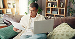 Budget, man and paperwork with laptop on sofa for financial planning, internet banking and reading insurance bills. Finance, person and documents in home for debt review, asset management and website