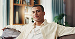 Home, sofa and man in portrait for relax, comfortable and self care for mental health in living room. House, male person and smile on couch for chilling, resting and confidence with peace in lounge