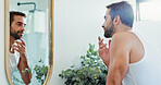 Man, mirror or hygiene with beard for grooming, morning routine or face wash in bathroom at home. Male person, clean or fresh trim with smile for facial treatment, skincare or reflection at house