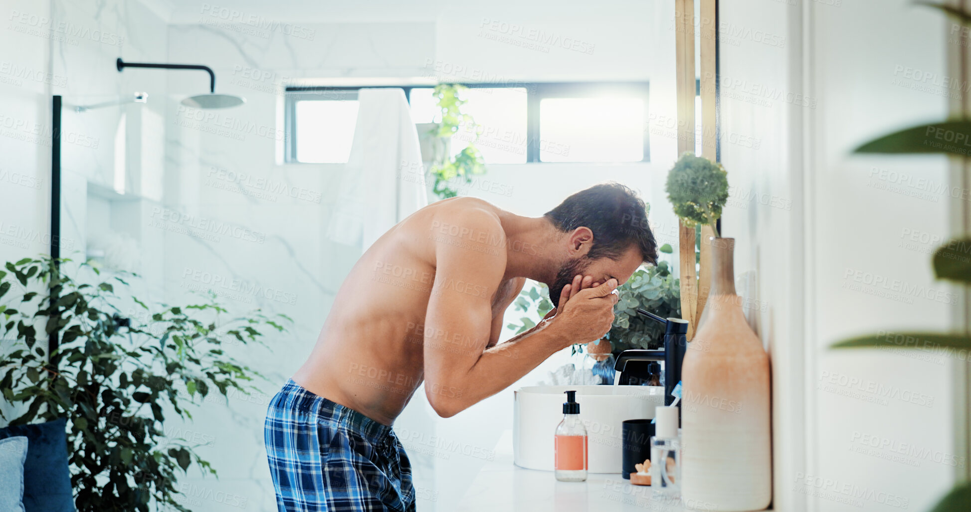 Buy stock photo Man, tap and washing face with water for hygiene, grooming or morning routine in bathroom at home. Male person, rinse or cleanliness with faucet for facial treatment, skincare or disinfect at house