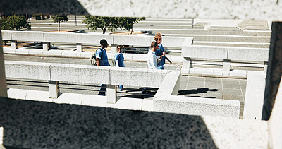 Buy stock photo Medical, people and students walking outdoor on bridge for discussion, education or advice with lecturer. College campus, healthcare nurse and group in city for travel, commute and internship above
