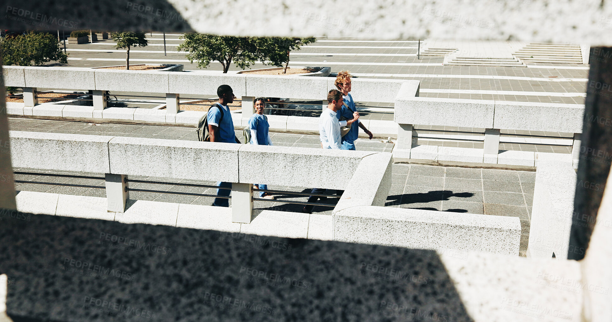 Buy stock photo Medical, people and students walking outdoor on bridge for discussion, education or advice with lecturer. College campus, healthcare nurse and group in city for travel, commute and internship above