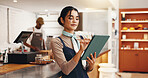 Employee, typing or woman in coffee shop, tablet or friendly service with supply chain. Retail person, restaurant manager or business owner in cafe, tech or with digital app for menu or ecommerce
