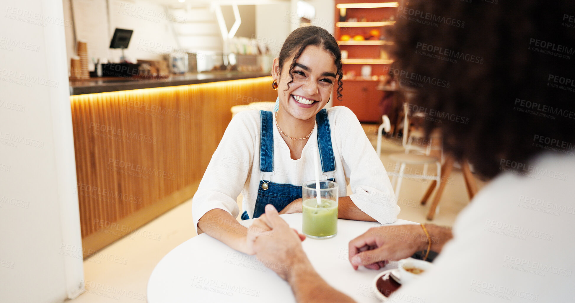 Buy stock photo Talking, holding hands and couple in coffee shop on date for bonding, relationship and love. Restaurant, cafe and man with woman with drink, beverage and matcha for conversation, relax and chatting
