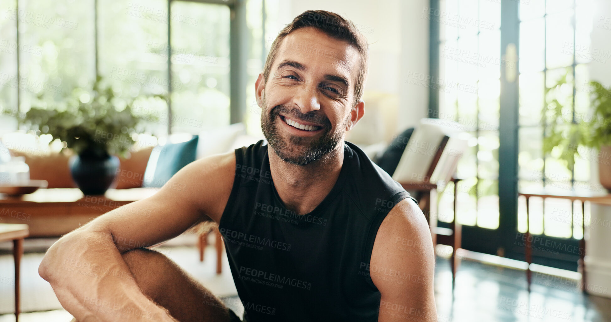 Buy stock photo Portrait, happy and man in living room, fitness and healthy in home, exercise and athlete with sportswear. Morning, routine and person on break for workout, wellness and smile in lounge in Canada