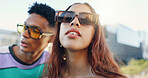 Sunglasses, trendy and couple in city with fashion in summer for urban, edgy and cool style together. Streetwear, gen z woman and creative people in town for youth culture, unique outfit and swag