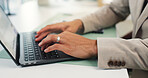 Business person, hands and typing with laptop on desk for schedule, design or research at office. Closeup, employee or designer working on computer for communication, network or email at workplace