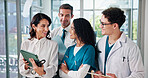 Happy team, doctor or meeting with tablet for medical research, discussion or development at hospital. Group, employees or healthcare workers with smile on technology for online app or telehealth