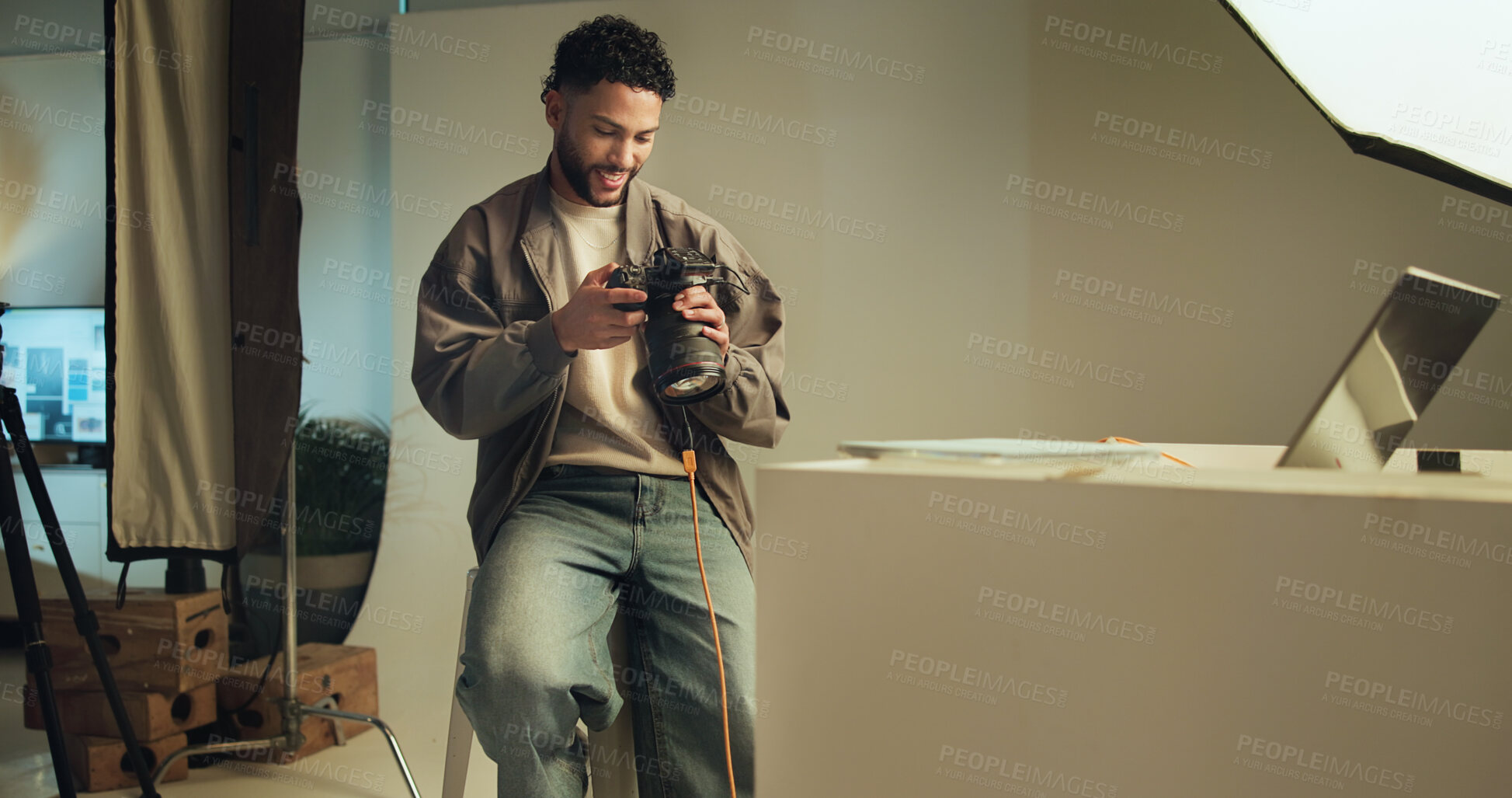 Buy stock photo Man, photographer and check camera in studio for photoshoot results, catalog and review selection. Smile, person and tech with lens focus, film production and editing picture for photography industry