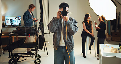 Camera, lighting and shooting with photographer man in studio for lens focus or photoshoot. Backstage, creative or production with makeup artist and model getting ready for photography on set