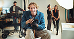 Camera, portrait and smile of photographer man in studio for start of professional photoshoot. Backstage, happy or laughing with makeup artist and model getting ready for photography on film set