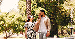 Holding hands, smile and couple on date, park and romance for people in nature, kiss or happy for walk. Outdoor, man and affection for woman, love and together for valentines day, care and commitment