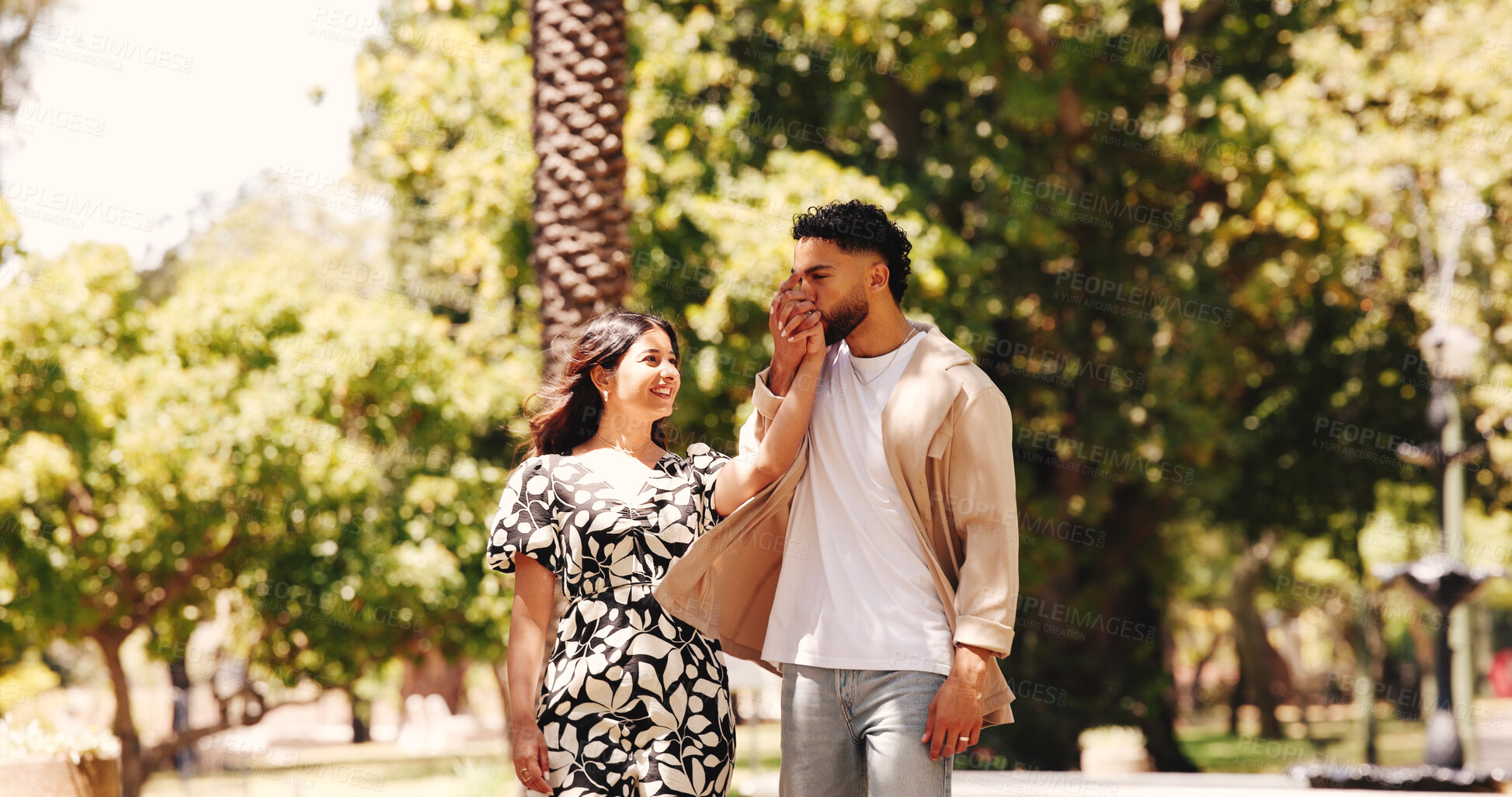 Buy stock photo Holding hands, smile and couple on date, park and romance for people in nature, kiss or happy for walk. Outdoor, man and affection for woman, love and together for valentines day, care and commitment