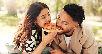 Buy stock photo Couple, lunch and eating pizza outdoor at picnic together for romantic date or bonding for relationship. Man, woman or share fast food at park, hungry or enjoy takeaway to relax with partner for love