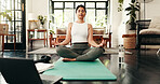 Laptop, meditation and yoga with woman in living room of home for health, pilates or wellness routine. Exercise, holistic and online course with Indian person in apartment for mindful balance