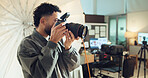 Photographer, camera and man in studio, skills and backstage with tech, entrepreneur and project. Person, employee or guy with professional, business for pictures and media agency for magazine