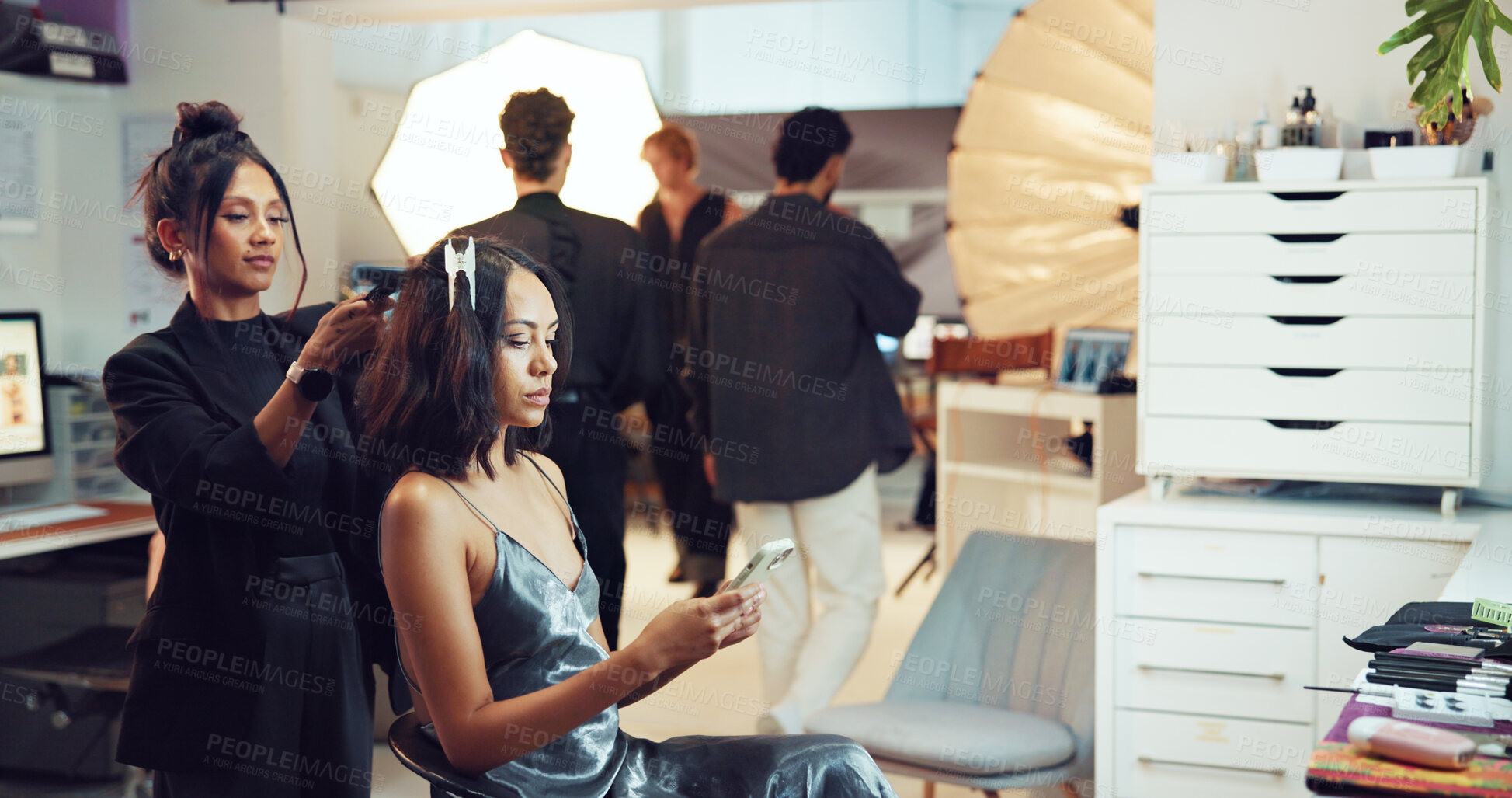Buy stock photo Hairstyling, phone or photography with makeup artist and model in studio for backstage preparation. Communication, getting ready and social media with woman on set for hair magazine photoshoot