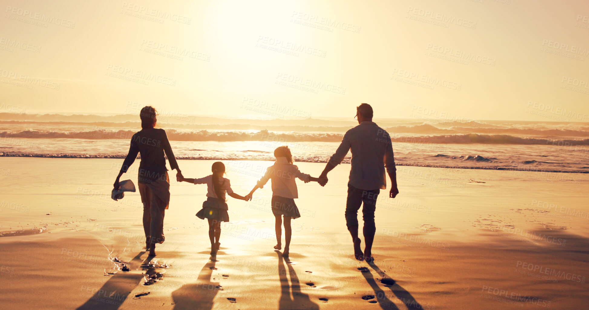 Buy stock photo Sunset, family and holding hands at beach for holiday, vacation and bonding together outdoor. Back, mother and father with children at ocean with mockup space, travel or summer adventure with parents