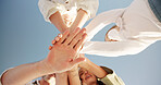 Hands stack, sky and unity of family, outdoor and bonding on vacation with children, love and below. Relationship, parents and kids on holiday, together and people with support on trip or care