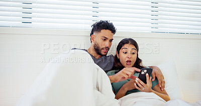 Buy stock photo Online shopping, phone and couple in bed with surprise for notification, website deal and internet. Shock, home and man and woman on smartphone for social media news, discount and sales on weekend