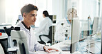 Man, scientist and typing on computer in lab of medical research, experiment and information. Person, microscope or online of healthcare report, biotech and investigation feedback of vaccine solution