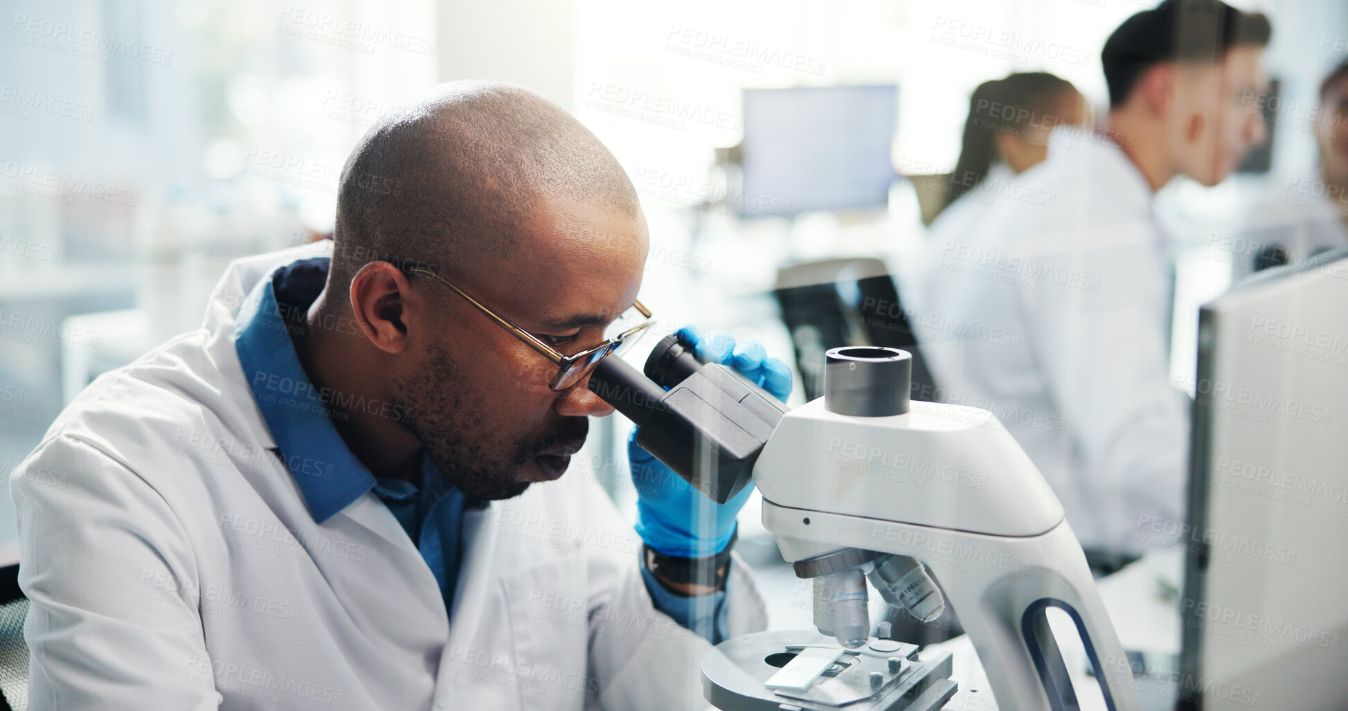 Buy stock photo Microscope, scientist and man with exam for research in laboratory, healthcare and medical innovation. Science, experiment and microbiology for drugs development, pharma study and biotechnology test