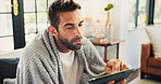 Home, man and sick with tablet for thermometer, check fever and influenza with research for symptoms. Sofa, male person and illness with temperature for flu, consultation and telehealth with digital
