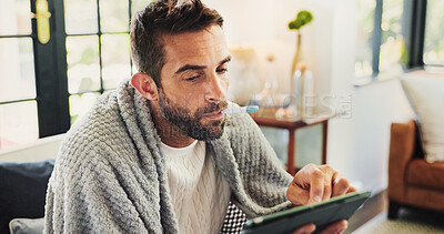 Buy stock photo Home, man and sick with tablet for thermometer, check fever and influenza with research for symptoms. Sofa, male person and illness with temperature for flu, consultation and telehealth with digital
