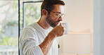 Coffee, computer and remote work with man in home office for break from planning or research. Aroma, cup and small business startup with freelance employee drinking caffeine beverage in apartment
