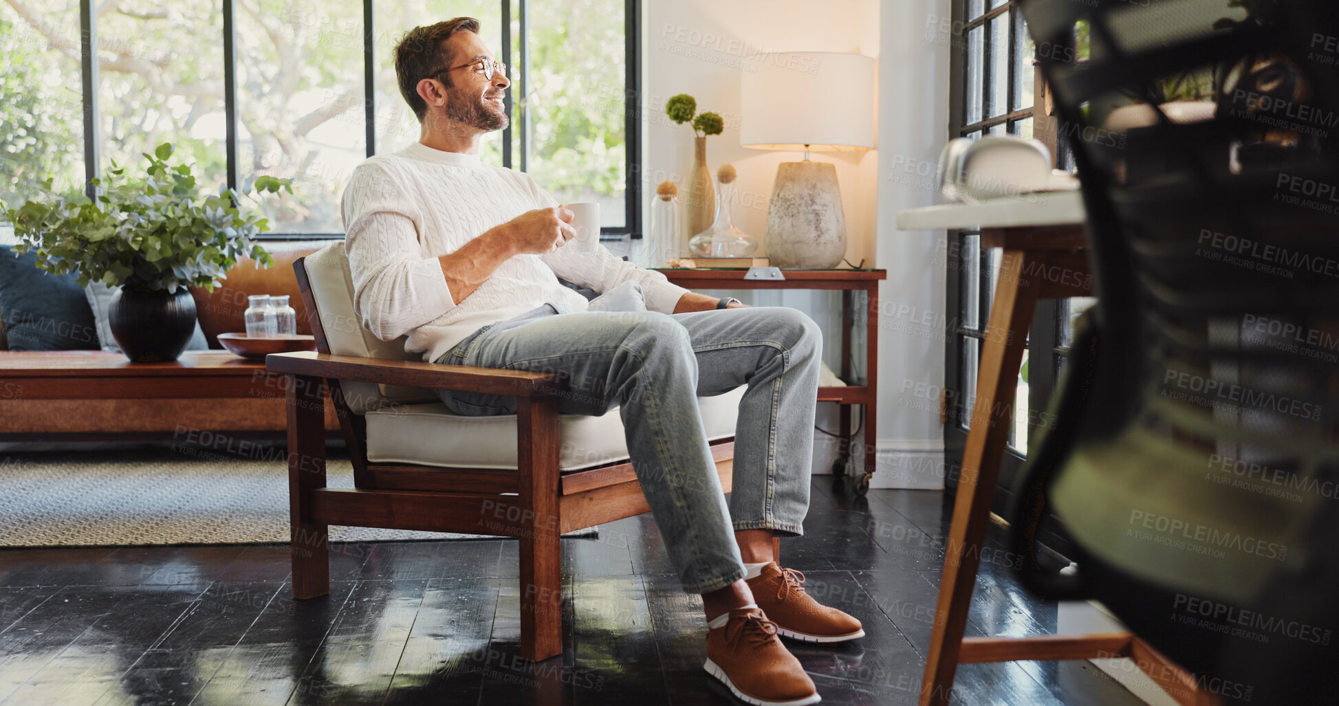 Buy stock photo Coffee, smile and thinking with man on chair in living room of home for break, satisfaction or wellness. Drink, future and planning with happy person in apartment for morning or weekend beverage